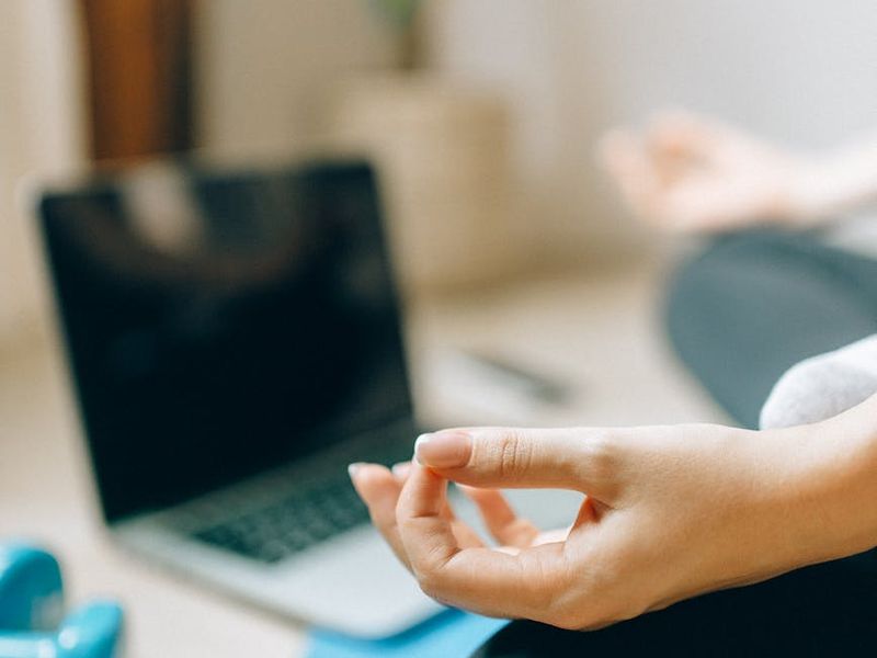 A cozy, well-lit room with a yoga mat on the floor.